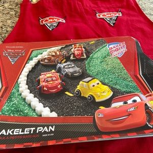 Williams and Sonoma Cars 2 cake pan and 2 child aprons.